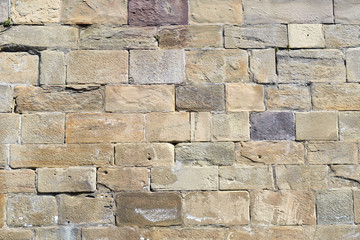 Obraz premium Old Multi-coloured Stone Wall in Bright Sun 