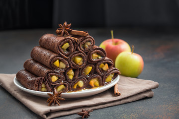 Chocolate crepes with apple pie filling with cinnamon. Homemade. 