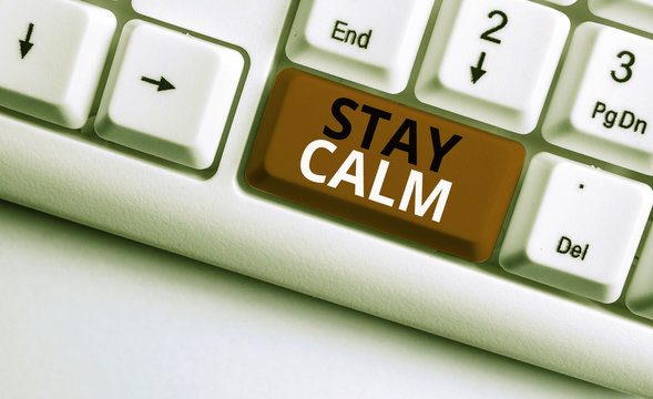 Writing note showing Stay Calm. Business concept for Maintain in a state of motion smoothly even under pressure White pc keyboard with note paper above the white background