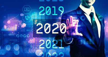 2020 New Year concept with businessman on blurred blue light background