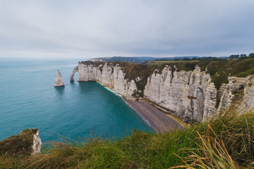 Panoramatic view on Etretat steep rock coastal cliffs at north of France, served as many inspiration for Monet, the impresionist painter