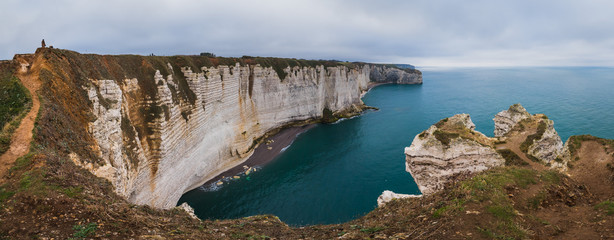 Fototapeta na wymiar Panoramatic view on Etretat steep rock coastal cliffs at north of France, served as many inspiration for Monet, the impresionist painter