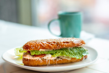 Sandwich with ham, cheese, tomatoes, lettuce and toasted bread. Side view isolated on a white background. Sandwich coffee in a coffee shop. Breakfast with a sandwich. Fast food on the street