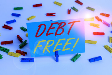 Text sign showing Debt Free. Business photo text does not owning any money or things to any individual or companies Colored clothespin papers empty reminder white floor background office