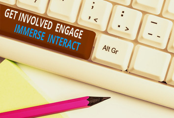 Writing note showing Get Involved Engage Immerse Interact. Business concept for Join Connect Participate in the project White pc keyboard with note paper above the white background