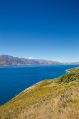 Lake in mountains, New Zealand landscape, blue sky and water, scenic view of Lake Hawea