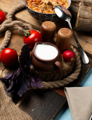 basil, tomato, salt and yogurt with wooden background
