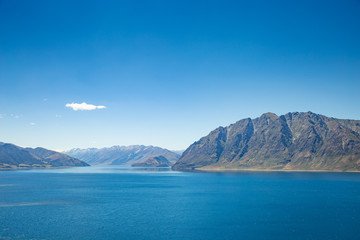 Lake in mountains, New Zealand landscape, blue sky and water, scenic view of Lake Hawea