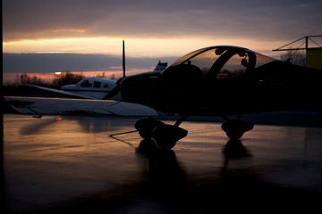 Fototapeta na wymiar Flight academy in sunset aircraft hangar