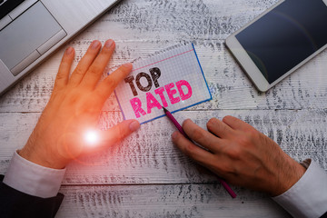 Writing note showing Top Rated. Business concept for The high amount of a charge or payment based...