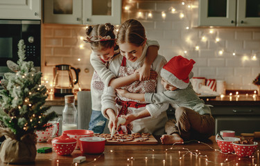 happy family mother and children bake christmas cookies.