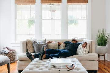 Man sleeping on couch at home