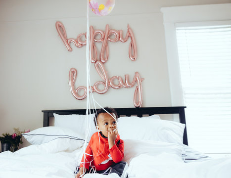 Baby Playing With Birthday Balloons