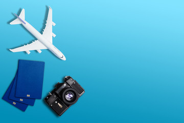 top view travel concept with retro camera films, passport on blue background with copy space, Tourist essentials, vintage tone effect