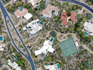 Aerial top view of upscale luxury homes with pool and tennis court in Scottsdale, Phoenix, Arizona