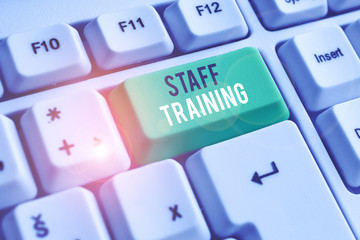 Handwriting text writing Staff Training. Conceptual photo program that helps employees learn specific knowledge White pc keyboard with empty note paper above white background key copy space