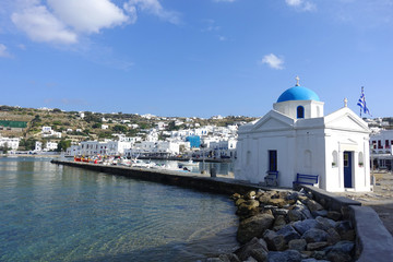 Picturesque port and main village of Mykonos island with traditional fishing boats and beautiful...