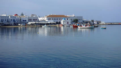 Fototapeta na wymiar Picturesque port and main village of Mykonos island with traditional fishing boats and beautiful sunny weather, Cyclades, Greece