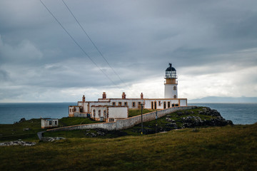 Fototapeta na wymiar Close view to the nest point lighthouse located on isle of Skye in Scotland under cloudy sky