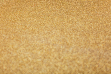 Abstract blurred gold sparkle bakground.