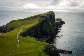 Famous lighthouse on isle of Skye in Scotland, Point nest, view over the approaching path, over the green meadow
