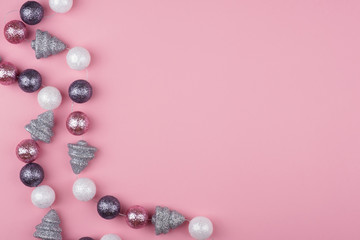 Christmas garland on a pink background. Flat lay, top view