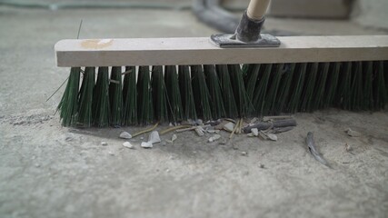 Primer for concrete floor. The master lays liquid soil on a concrete floor. Primer worker on...