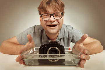 Crazy technician cleaning digital camera bad way in water
