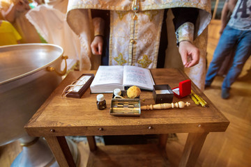 The sacrament of baptism. Attributes of an Orthodox priest for baptism. Baptism in the font. Child...