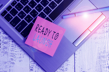 Conceptual hand writing showing Ready To Launch. Concept meaning an event to celebrate or introduce something new to market Open slim metallic laptop blank sticky pad pen lying vintage table