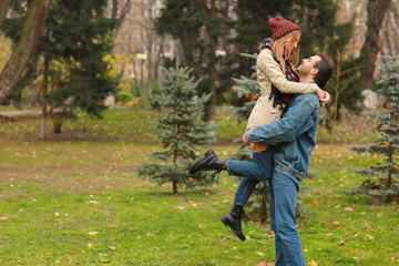 Happy couple resting in autumn park