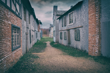 Narrow street in the old European city of brick and wooden buildings of the 18-19th century