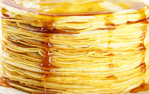 Stack of pancakes dripping with syrup