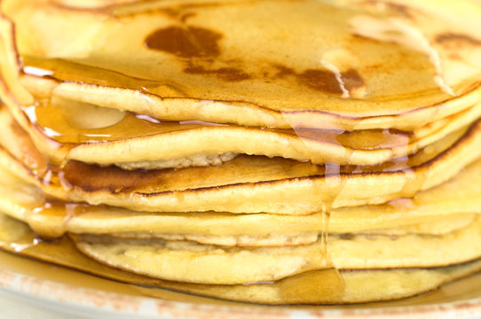 Stack of pancakes dripping with syrup