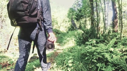 Traveler photographing scenic view in forest. One caucasian woman shooting nice magic look. Girl take photo video on dslr mirrorless camera. Professional photographer travel with backpack. Outdoor.