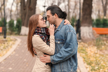 Happy couple walking in autumn park