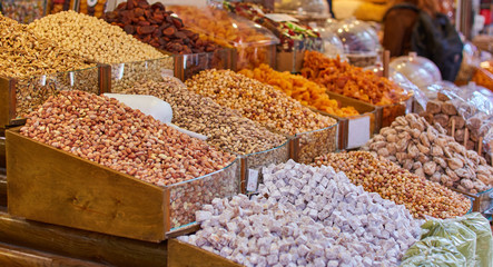 Pistachio, walnut, almond, , and nut in round metal trays in an authentic bazaar