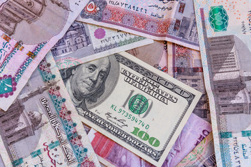 American one hundred dollar banknote on heap of the egyptian money