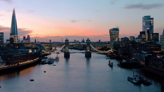 Aerial view of City of London Skyline, The Shard, Tower Bridge and Thames River at dusk in London