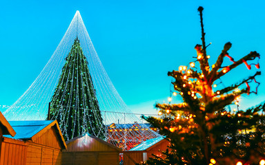 Night Cityscape with Christmas Market at Cathedral square in Winter Vilnius, Lithuania. Advent Fair Decoration and Stalls with Crafts Items on the Bazaar. Lithuanian street Xmas and holiday