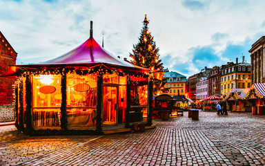 Tree at Night Christmas Market on Dome square in Winter Riga, Latvia. Advent Fair Decoration and...