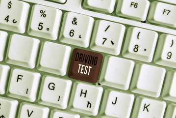 Handwriting text writing Driving Test. Conceptual photo procedure to test a demonstrating s is ability to drive a motor vehicle White pc keyboard with empty note paper above white background key copy