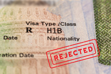 Rejected stamp on passport visa page. H1-B is temporary work visa for foreign skilled workers in specialty occupation for doctors, engineers, nurses, statistics etc. Fragment stamp. 