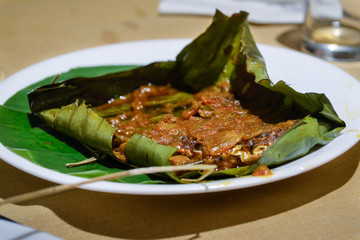 Kerala, India traditional fish curry coconut on banana leaf