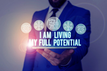 Handwriting text writing I Am Living My Full Potential. Conceptual photo Embracing opportunities using skills abilities Male human wear formal work suit presenting presentation using smart device