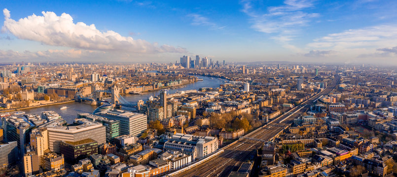 Panoramic aerial view of London, UK. Beautiful skyscrapers, river Thames and railway going through the city.