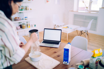 Crop woman cooking pastry dish