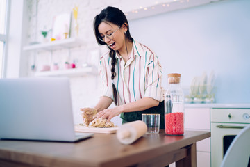Attractive lady kneading dough with pleasure