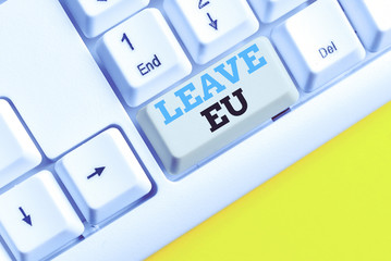 Handwriting text Leave Eu. Conceptual photo An act of a demonstrating to leave a country that belongs to Europe White pc keyboard with empty note paper above white background key copy space