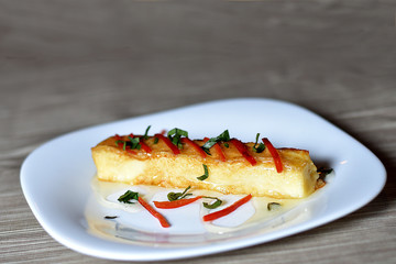 baked cheese served with honey and pepper